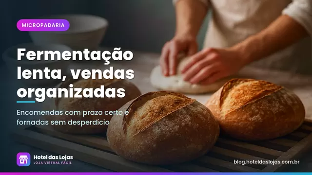 Pães de fermentação natural com casca dourada esfriando em grade de madeira numa micropadaria